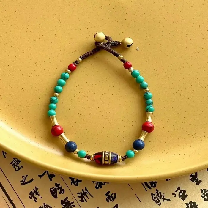 Bracelet tressé tissé à la main de style tibétain ancien, avec clochette exotique du Népal, pour fem