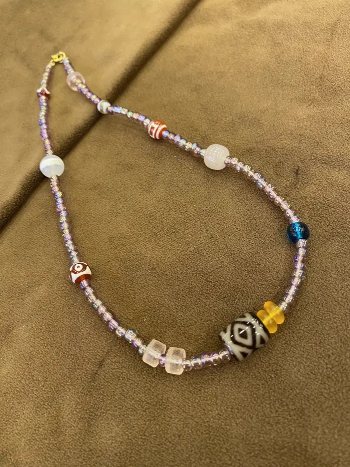 Collier de perles irisées violettes avec accents multicolores