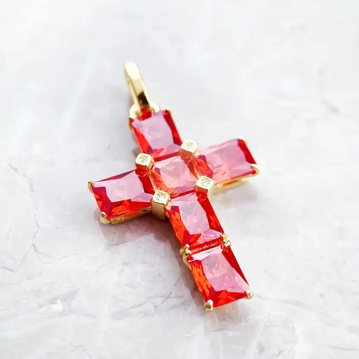 Pendentif croix dorée avec pierres orange