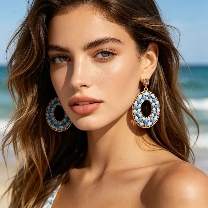 Boucles d'oreilles pendantes en raphia tressé bleu dégradé avec monture dorée et cristaux étincelants